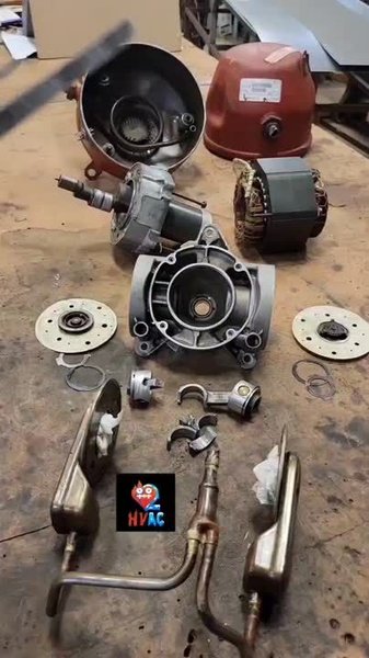 Disassembled compressor on a workbench showing internal components