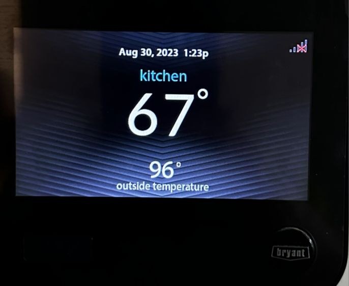 Bryant thermostat showing 67°F in kitchen with 96°F outdoor