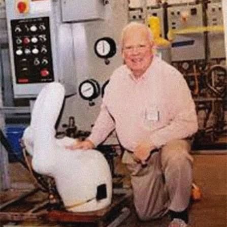 A Trane technician posing with Snowball at the Tyler, Texas test lab